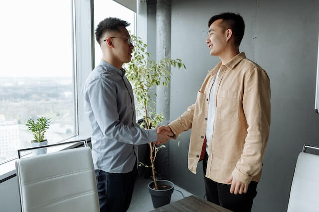 two people meeting and shaking hands for tenant interview