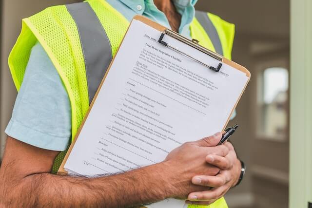 person-holding-rental-inspection-checklist