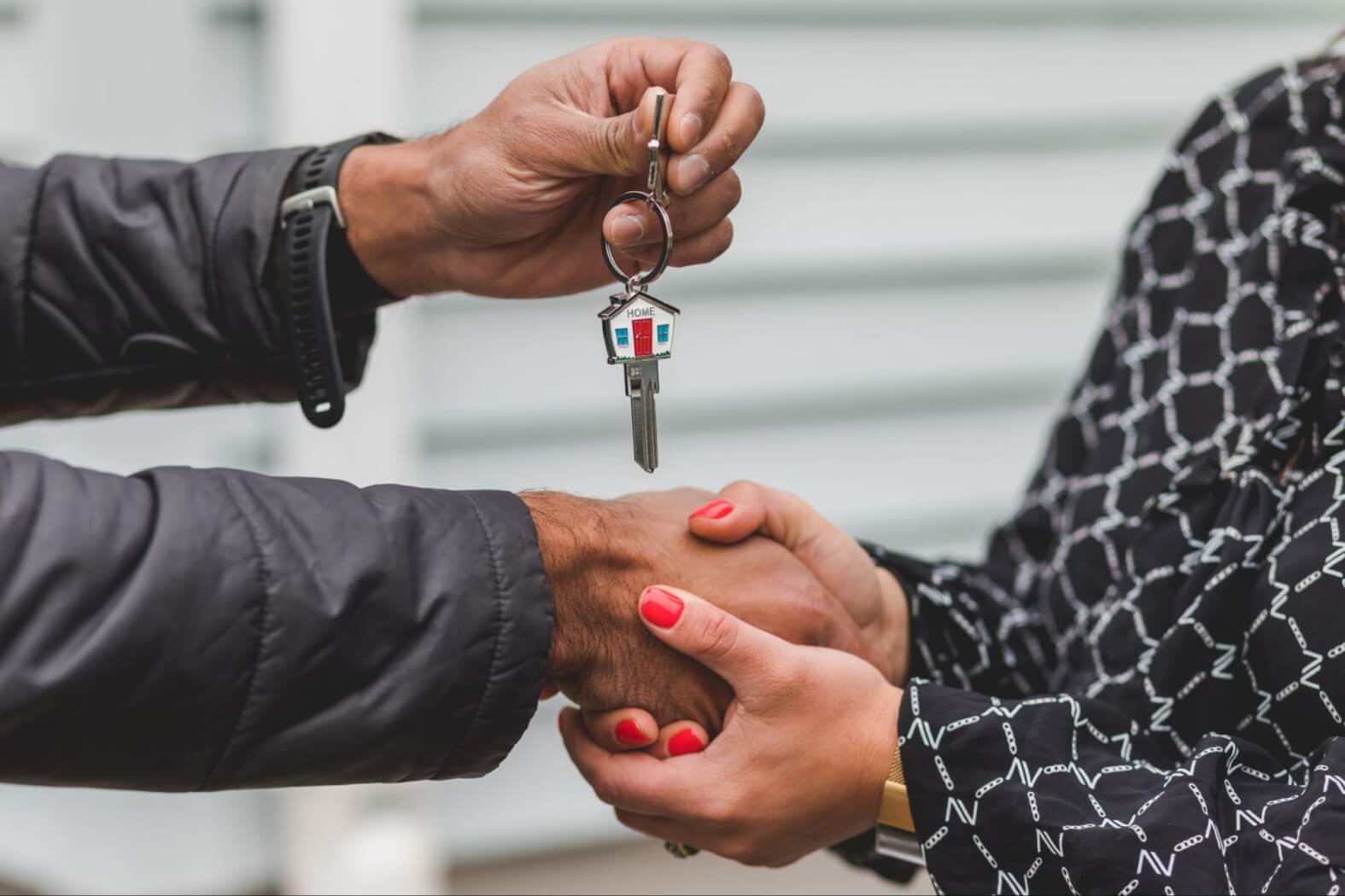 someone-handing-over-a-house-key-to-another-person